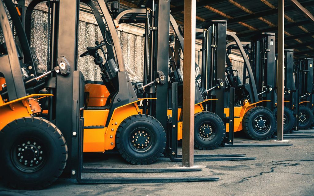 Side view of a row of yellow and black forklifts What Factors Affect a Forklift's Lifting Capacity? HTX Material Handling, Houston