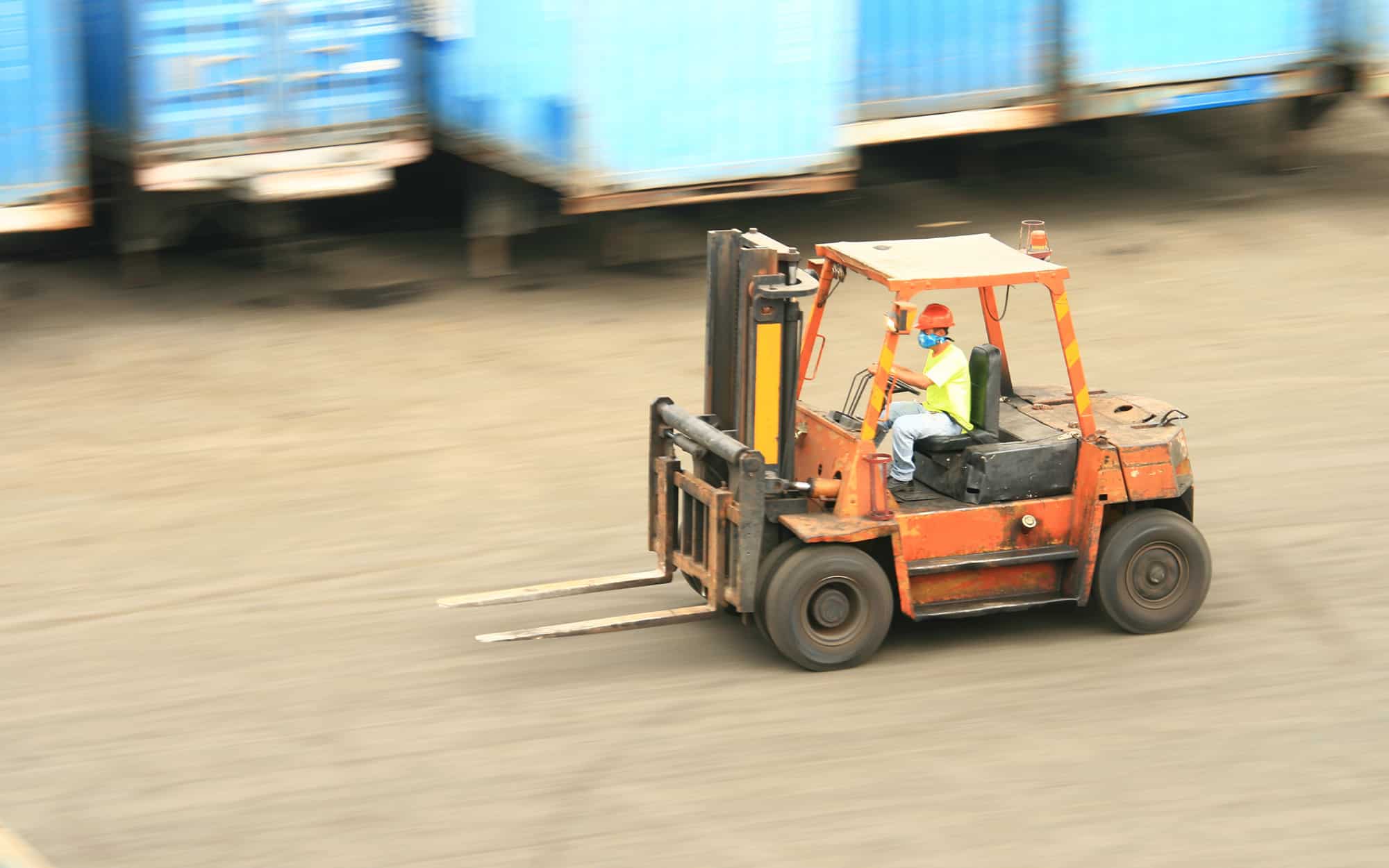 Image of two workers inspecting a forklift.