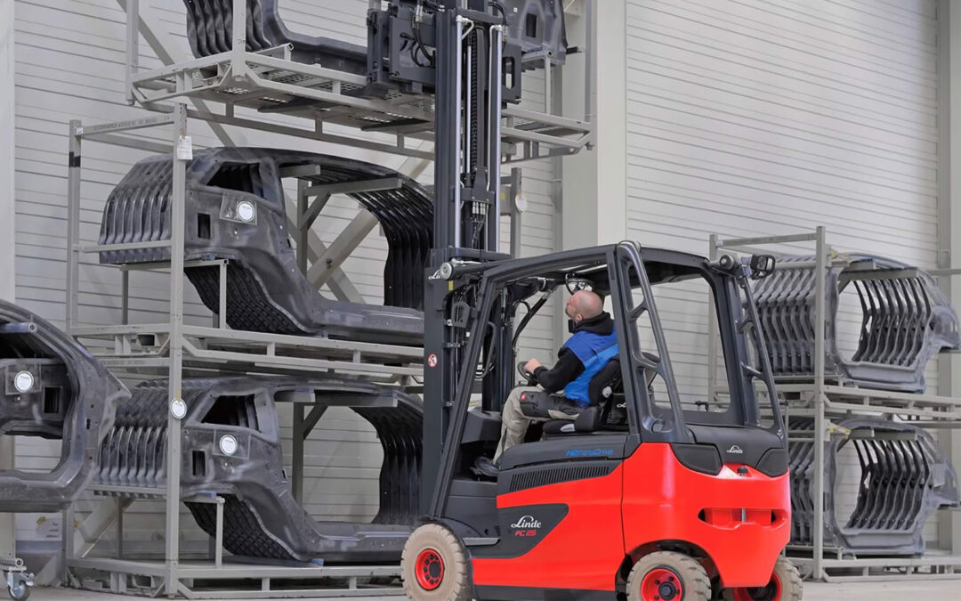 Side view of a man lifting something with a Hydrogen Fuel Cell Forklift