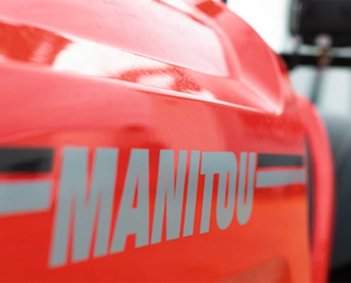 Close up side view of a piece of Manitou equipment