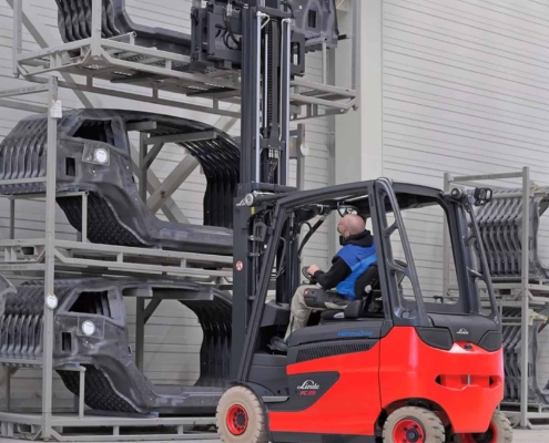 Side view of a man lifting something with a Hydrogen Fuel Cell Forklift