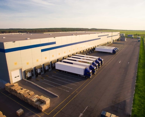 Trucks Loading Packages At Warehouse